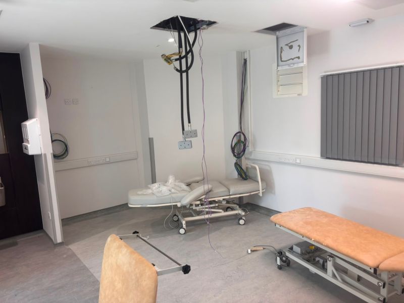Treatment room with ceiling-fed power and data cables during installation