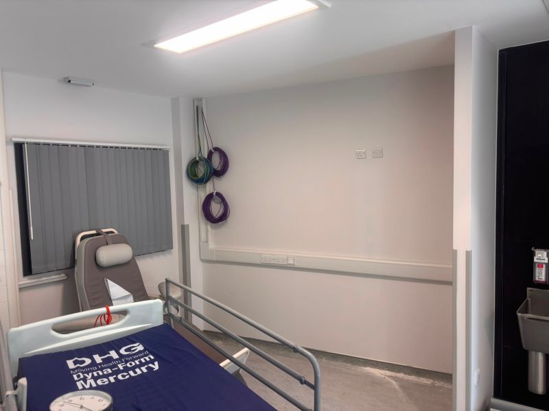 Clinical room at the Countess of Chester Hospital with dado trunking, socket outlets and a recessed light fitting