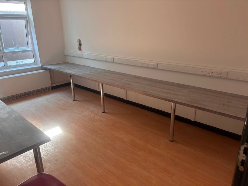 Support room with a run of socket outlets fitted above a worktop