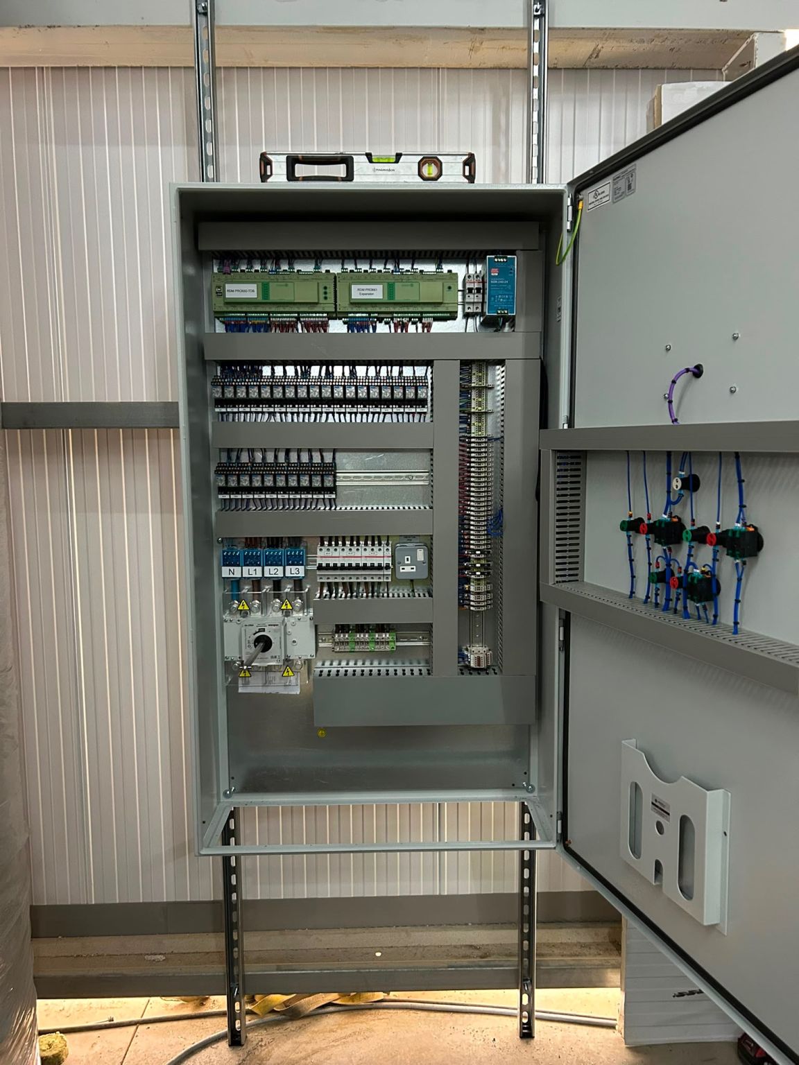 Open control panel with terminals, relays and an isolator on a Bolt Group site in Evesham